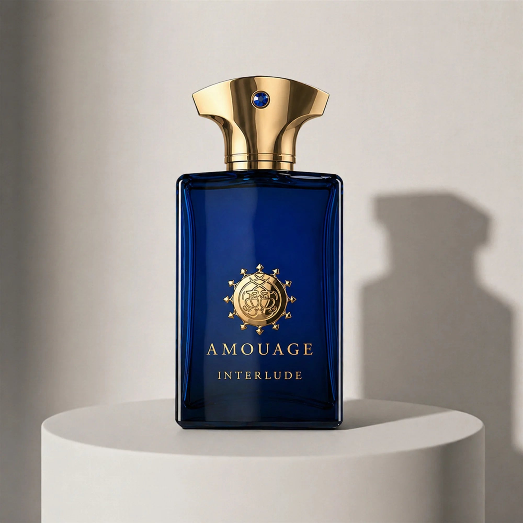 Amouage Interlude Man eau de parfum in deep blue glass bottle with gold cap – full-size bottle available at luxuryperfumesamples.com