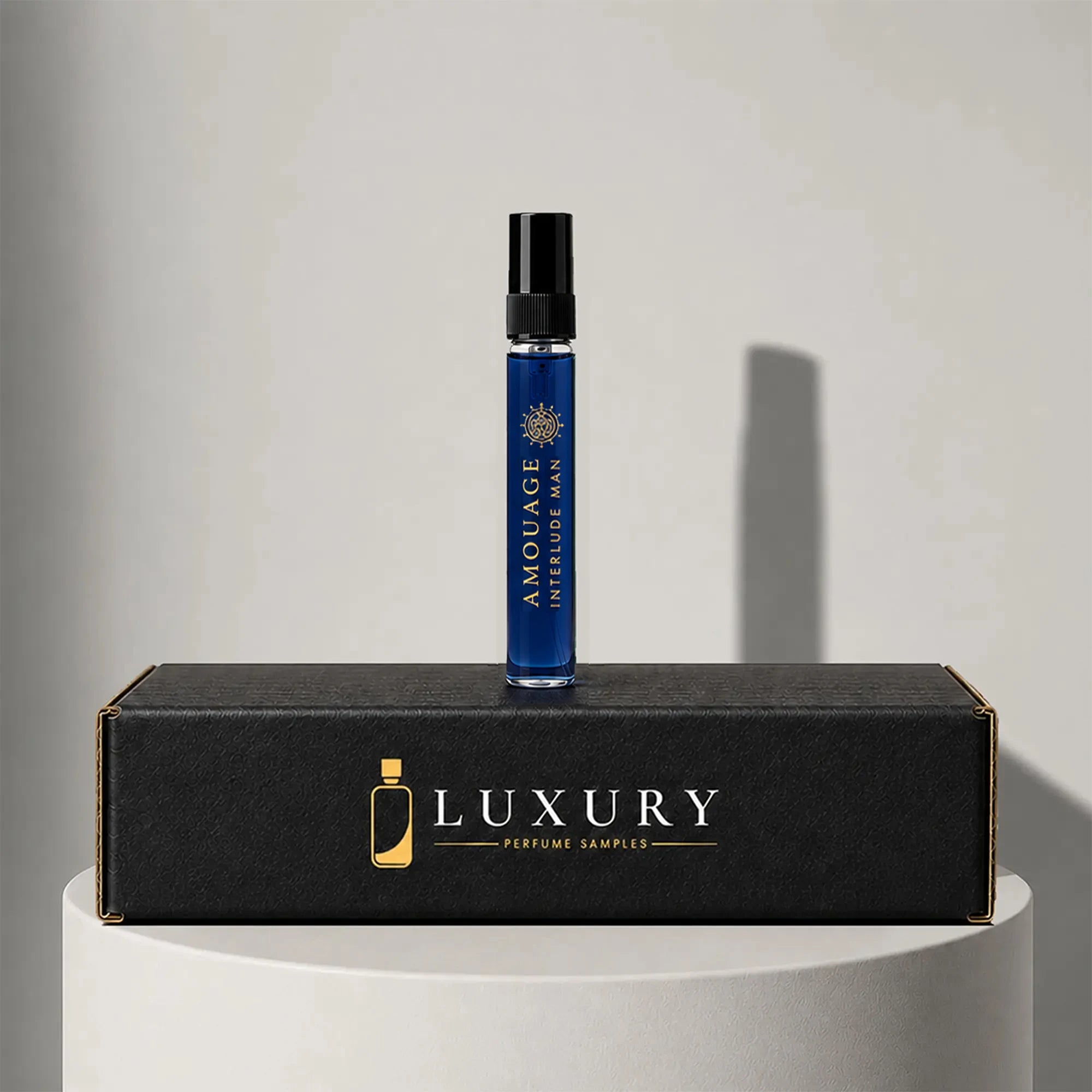 Amouage Interlude Man eau de parfum sample vial in deep blue glass, displayed on Luxury Perfume Samples branded box – sample decant available at luxuryperfumesamples.com
