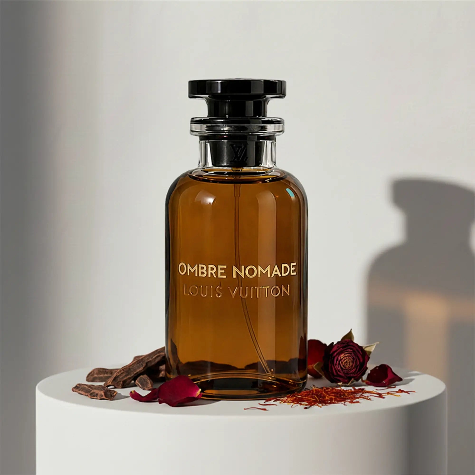 Louis Vuitton Ombre Nomade eau de parfum in signature amber glass bottle with black cap and stopper – full-size bottle available at luxuryperfumesamples.com