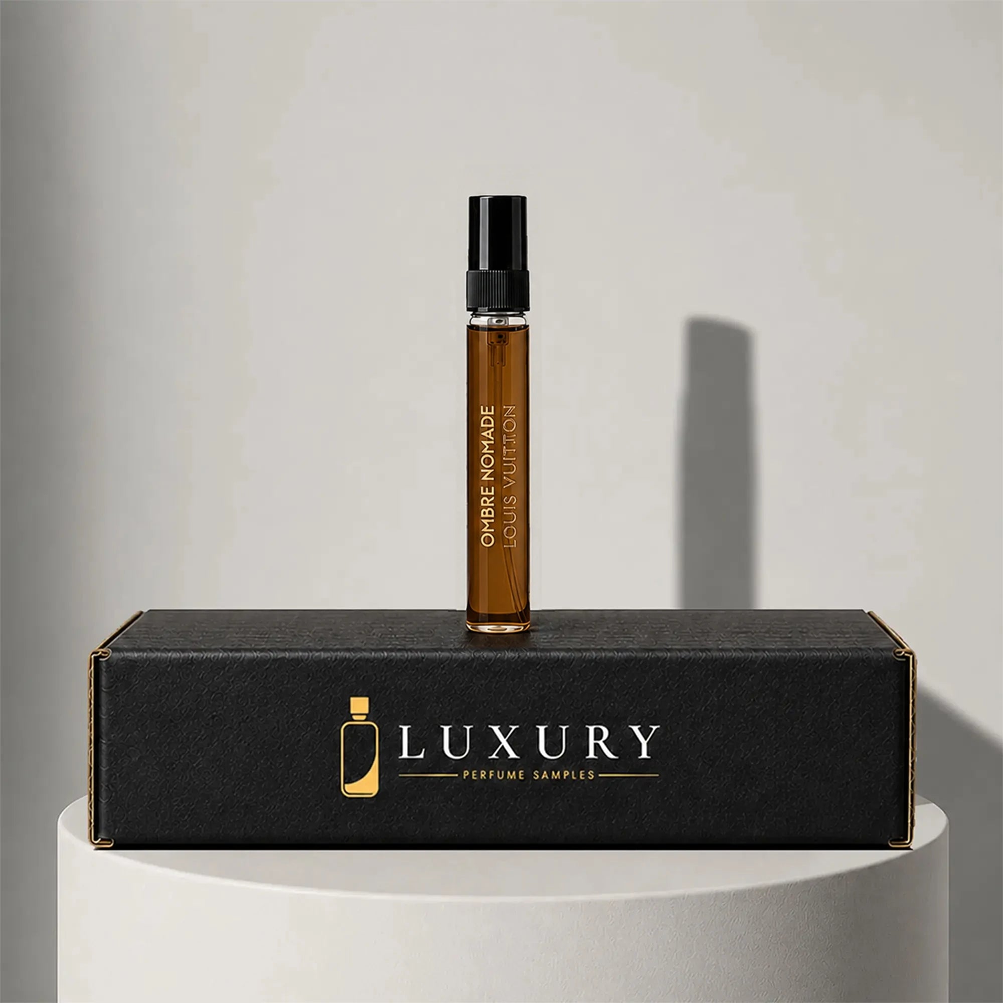 Louis Vuitton Ombre Nomade eau de parfum sample vial with black cap, displayed on Luxury Perfume Samples branded box – sample decant available at luxuryperfumesamples.com