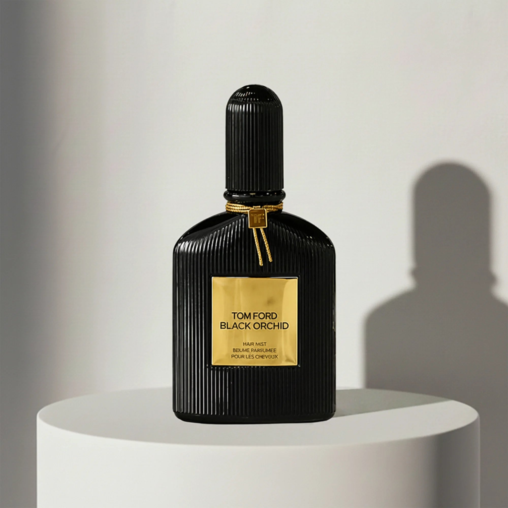 Tom Ford Black Orchid eau de parfum in black ribbed glass bottle with gold cap – full-size bottle available at luxuryperfumesamples.com
