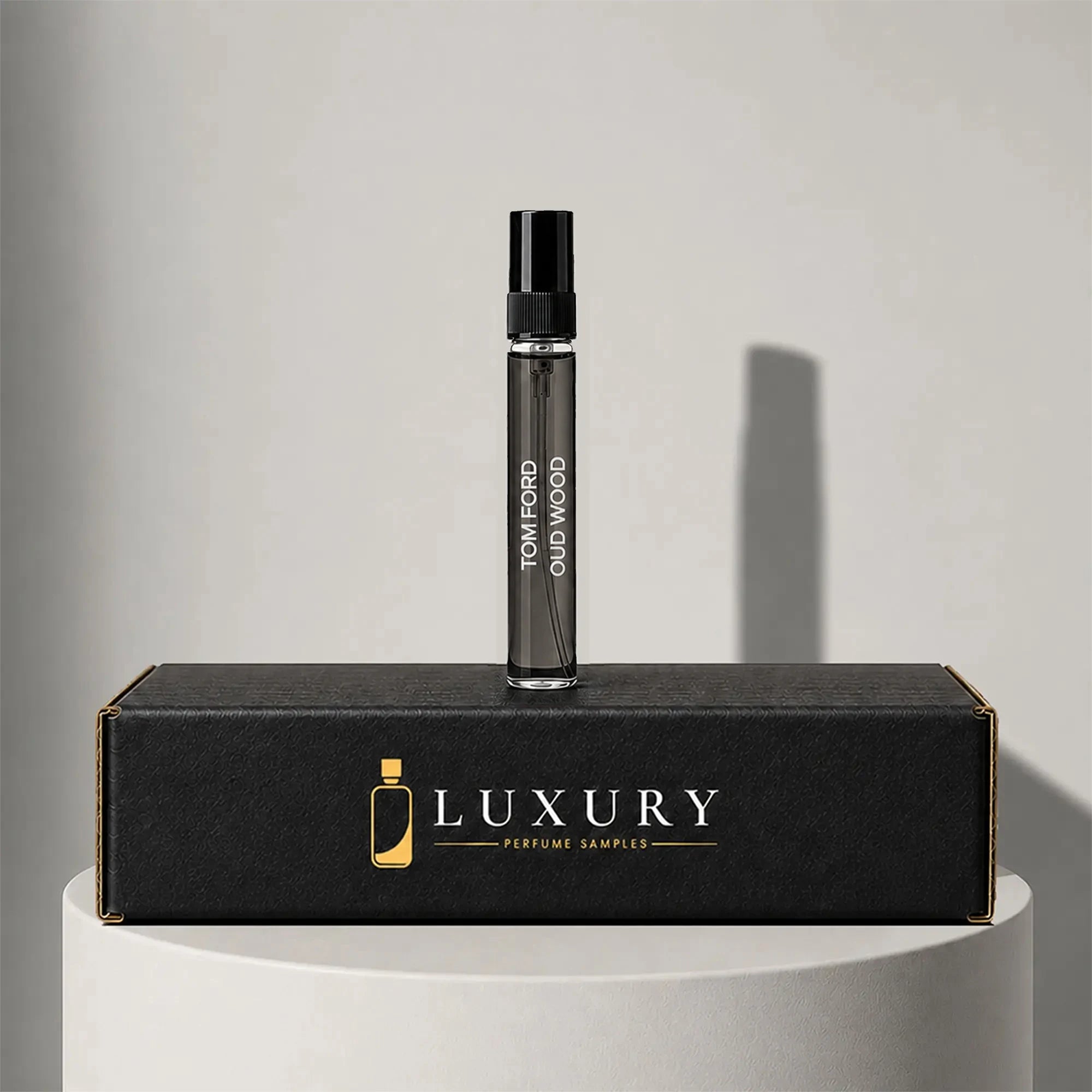 Tom Ford Oud Wood eau de parfum sample vial with black cap, displayed on Luxury Perfume Samples branded box – sample decant available at luxuryperfumesamples.com
